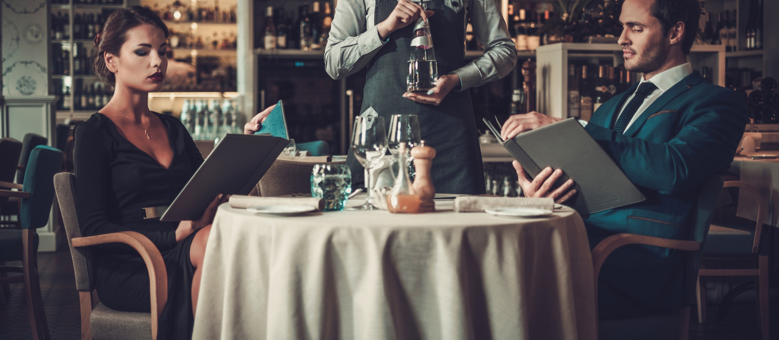 couple reading menu in a restaurant PVTFHPX